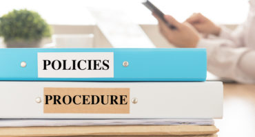 Policies,And,Procedures,Doucument,Place,On,Desk,In,Meeting,Room.